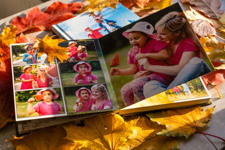 Photobook on the leaves background, closeup of photobook, family photo albumの写真素材