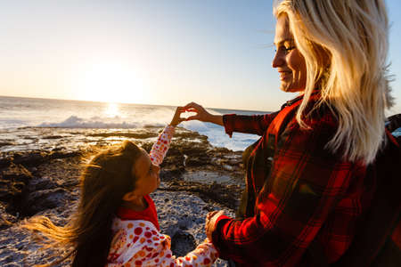 mother and daughter are walking near the ocean on the island of tenerifeの写真素材