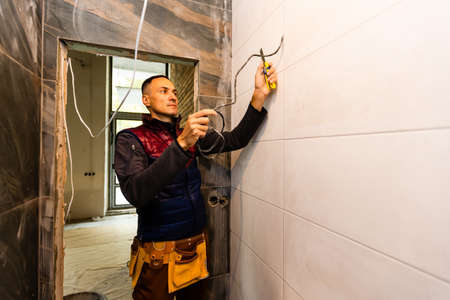 repair, renovation, electricity and people concept - of electrician handsの写真素材