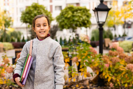 Little schoolgirl with backpack. Happy childhood. Beginning of academic year. Autumn time for studying. Studying in primary school. School education concept. Back to studyingの写真素材
