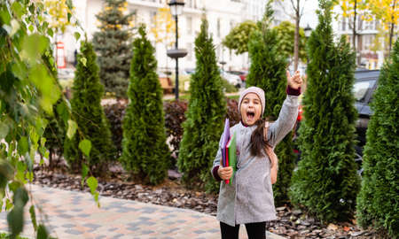 Beautiful little schoolgirl with a backpackの写真素材