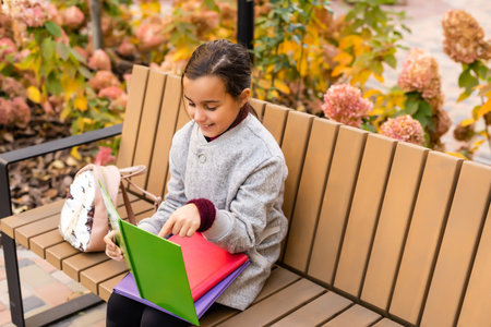 Little schoolgirl with backpack. Happy childhood. Beginning of academic year. Autumn time for...