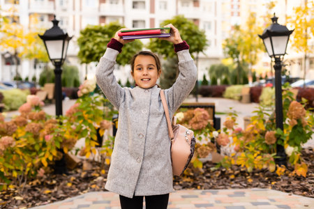 Beautiful little schoolgirl with a backpack