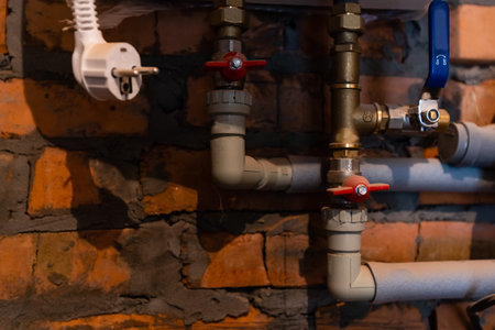 Pipelines with valves in a machine room.