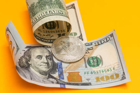 virtual money silver bitcoin on one dollar bill background. Concept of new world order of cryptocurrency. Dirty money and world conspiracyの写真素材