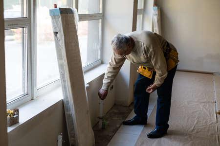 plumber at work. Installing water heating radiatorの写真素材