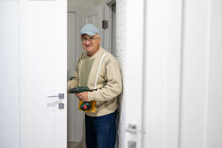 handyman repair the door lock in the roomの写真素材