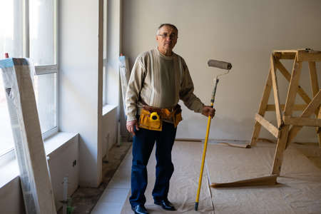 Portrait of a friendly painter at work in an apartmentの写真素材