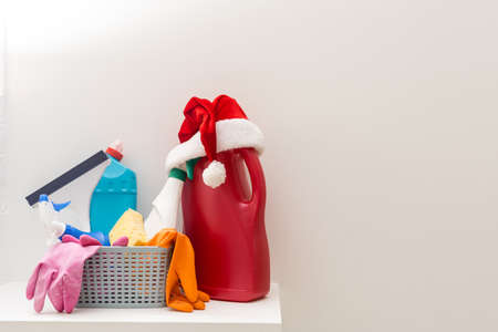 Cleaning before Christmas. Multicolored cleaning supplies. Sponges, rags and spray with festive decorations at homeの写真素材