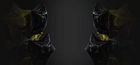 A group of black and gold balloons on a black background with copy space
