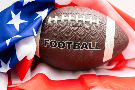 rugby ball on wooden table with us flag behind