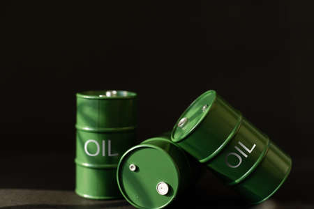 green oil tin barrels on black backgroundの写真素材