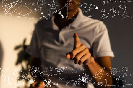 An image of a series of mathematical expressions and a hand pointing a finger at a formula. The image symbolizes the solution to the problemの写真素材
