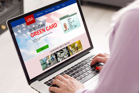woman with laptop Permanent resident card Green card of USAの写真素材