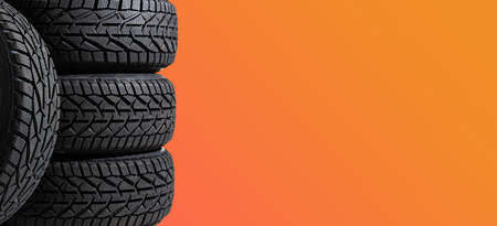 Winter car tires. Group of tires for winter driving on a yellow background.の写真素材