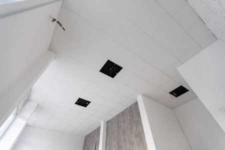 White ceiling in the office. White ceiling can reflect light well. The right light at work. Abstract...