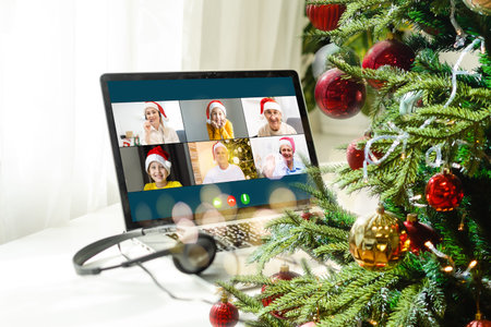 laptop with gift box and christmas lights background.