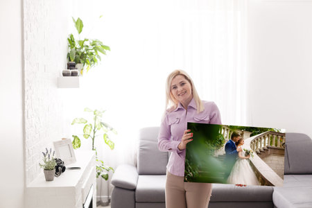 Woman holding wedding photography photo canvas print with gallery wrap.の写真素材