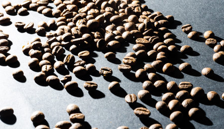 Several coffee beans isolated on black background with reflection. Culinary coffee background.