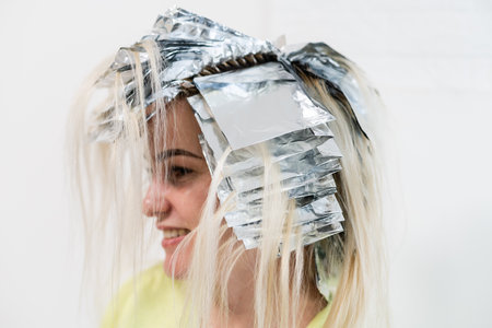 women having hair foiled in a beauty salonの写真素材