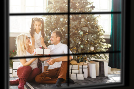 Big family with three children celebrating Christmas at home. Festive dinner at fireplace and Xmas...