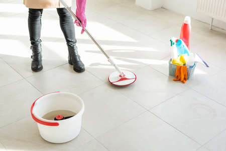 Spring cleaning woman cleaning floor with mopの写真素材