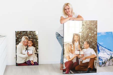 woman holding photo canvas on the background of a interiorの写真素材