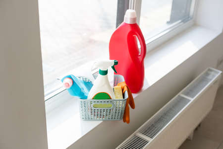 Cleaning service. Bucket with sponges, chemicals bottles and mopping stick. Rubber gloves. Household equipment.の写真素材