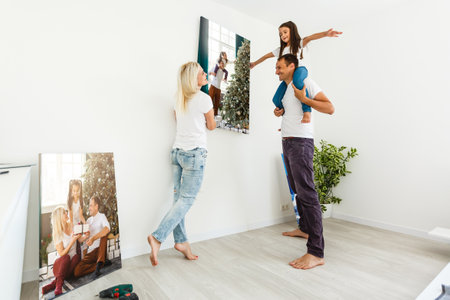 Smiling family holding photo canvasの写真素材