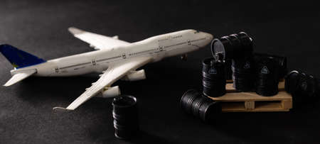 Miniature toy barrels and airplane. Business and finance concept.の写真素材