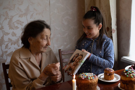 Easter cake in wrinkled hands of senior woman. Happy Easter concept, greeting card.