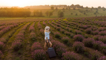 women with a suitcase and lavender field.