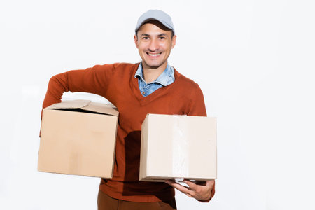 Smiling delivery man giving cardbox on white background