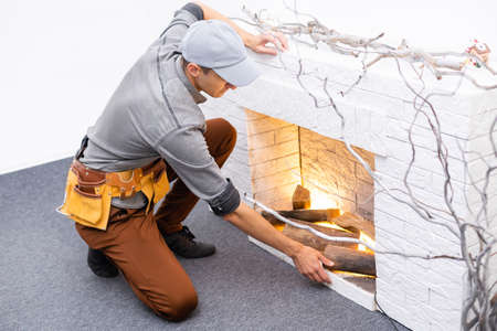 Finishing the fireplace. Putting plaster.の写真素材