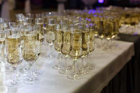 A row of wine glasses sitting on a tableの写真素材