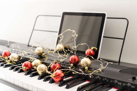 New Years composition on a musical synthesizer. lights of a garland. Merry Christmas greeting card. Happy New Year.の写真素材