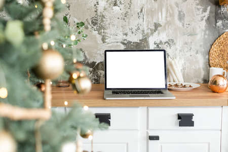 Laptop. Christmas tree and gifts on backgroundの写真素材