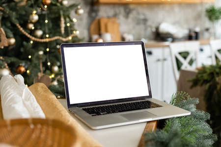 Laptop. Christmas tree and gifts on backgroundの写真素材