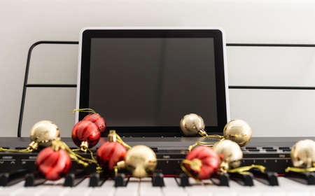 Top view close up shot of piano keyboard and Christmas decorationの写真素材