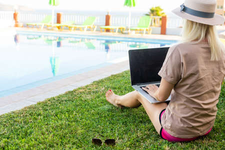 Beautiful Business Woman Working Online On Laptop Computer While Lying On Beach Lounger. Freelancer Girl Relaxing And Using Notebook Internet Work. Communication Technology.の写真素材
