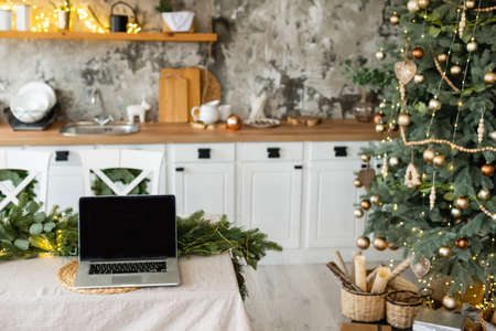 Laptop. Christmas tree and gifts on backgroundの写真素材