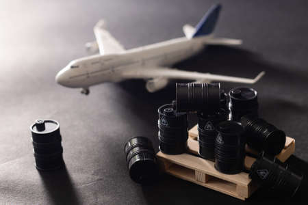 Miniature toy barrels and airplane. Business and finance concept.の写真素材