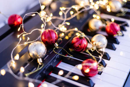 Top view close up shot of piano keyboard and Christmas decorationの写真素材