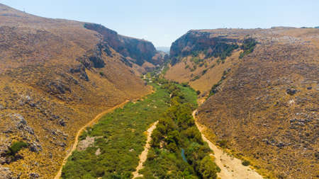 Panoramic view of summer Crete Greek Island near Preveli Lagoon with olive tree plantations mountains and Libyan Sea in backgroundの写真素材