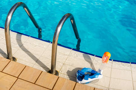 Scuba diving mask and snorkeling lies by the pool.の写真素材