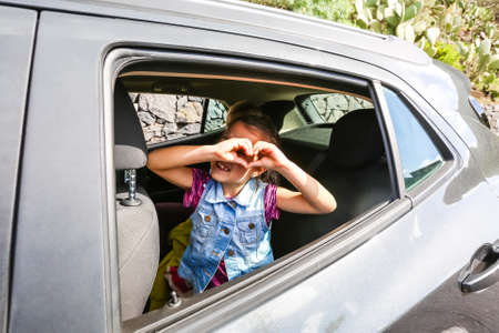 girl in the car looking throw windowの写真素材
