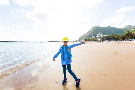 Adorable happy smiling little girl on beach vacationの写真素材
