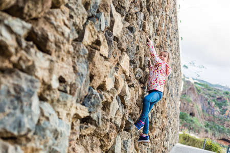girl on the stone wallの写真素材