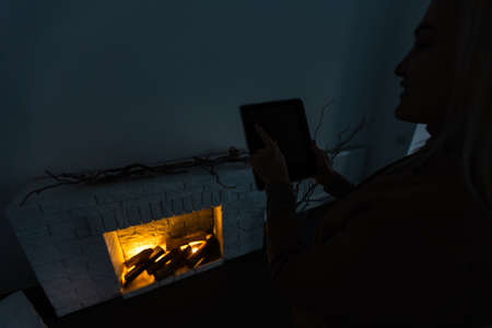 Smart Home: woman Controlling Blinds With His tabletの写真素材