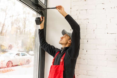 Man fixing locks with screwdriver in a new houseの写真素材